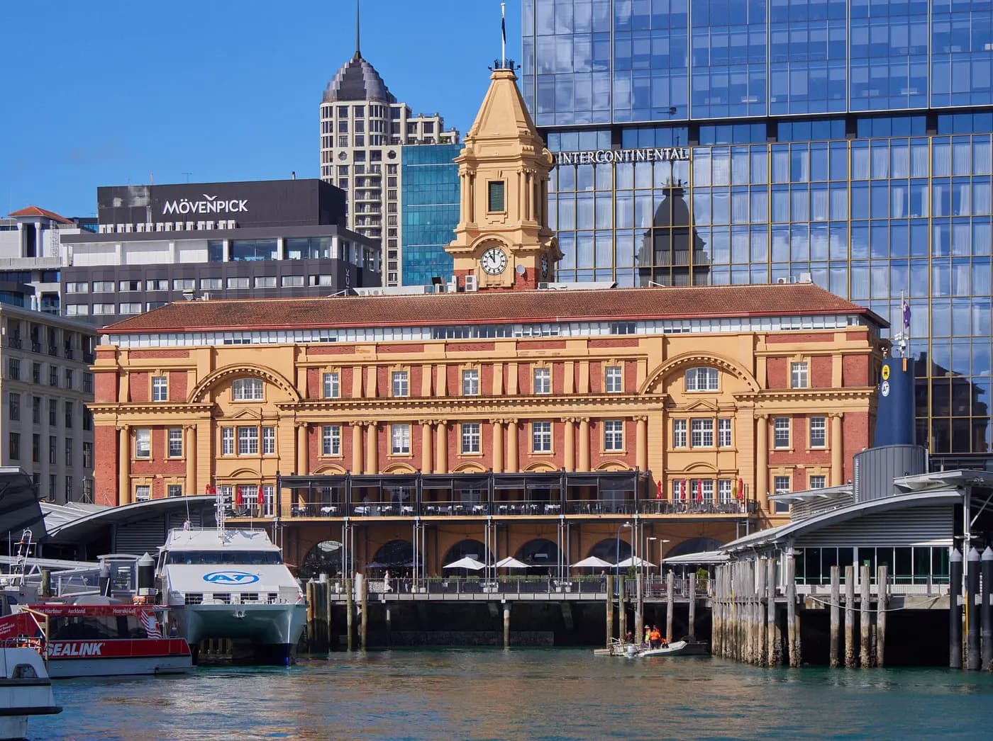 The 1912 Ferry Building with its clock tower on the Auckland waterfront, ferries moored in front
