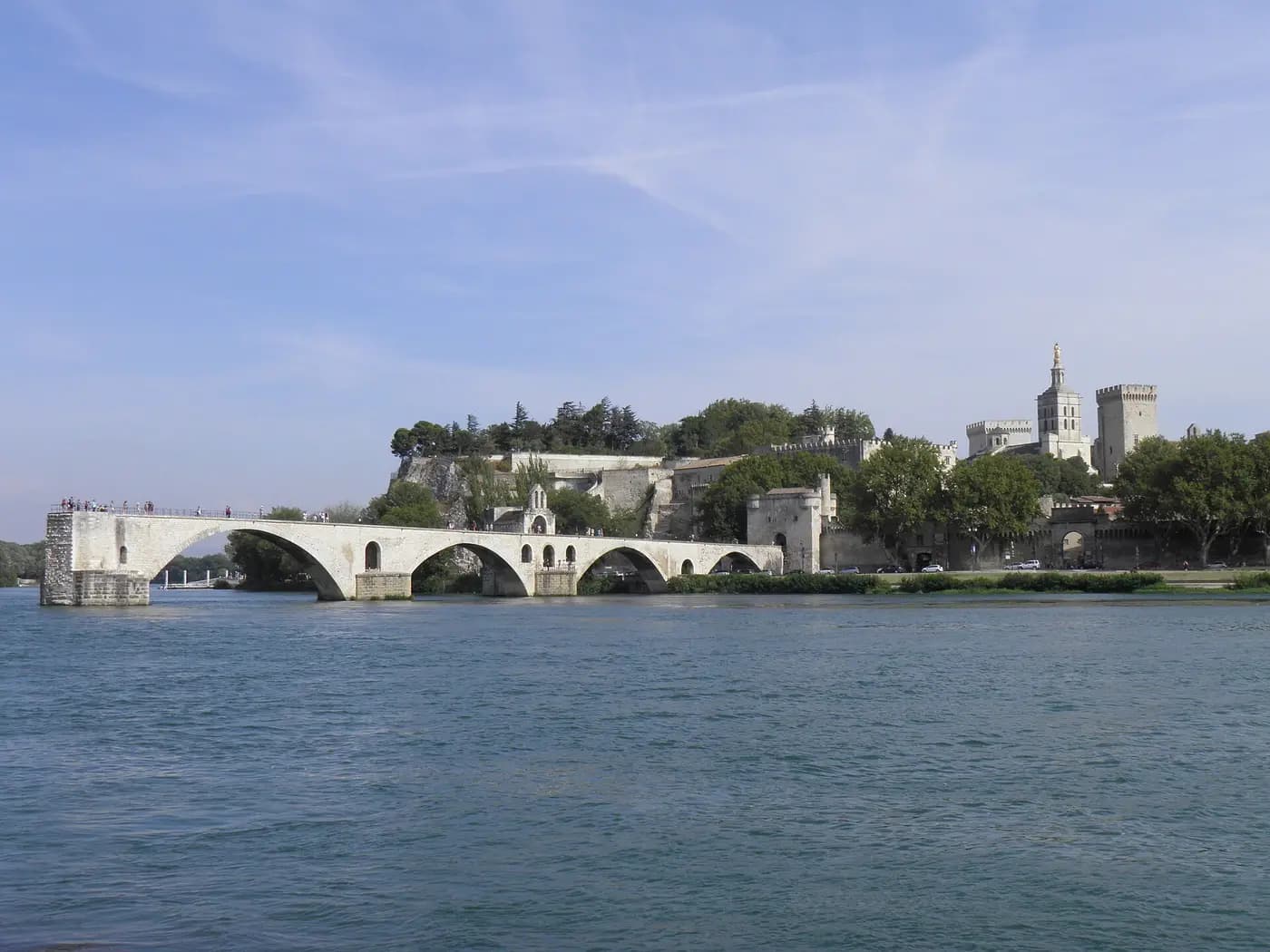 The broken arches of the Pont d'Avignon on the Rhône, with the Palace of the Popes beyond