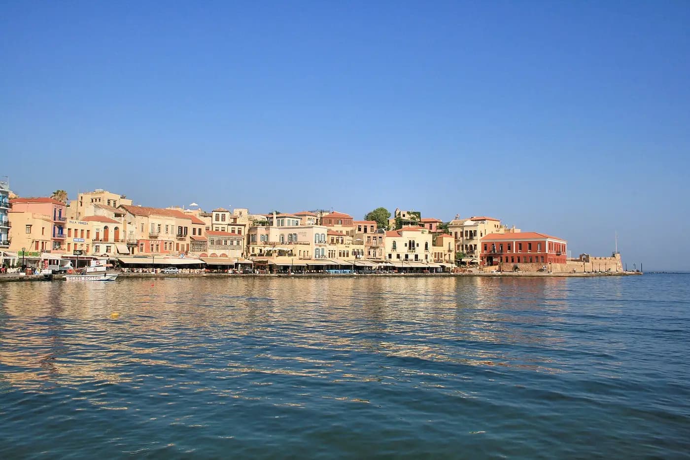 Pastel waterfront houses along the old Venetian harbour of Chania in western Crete