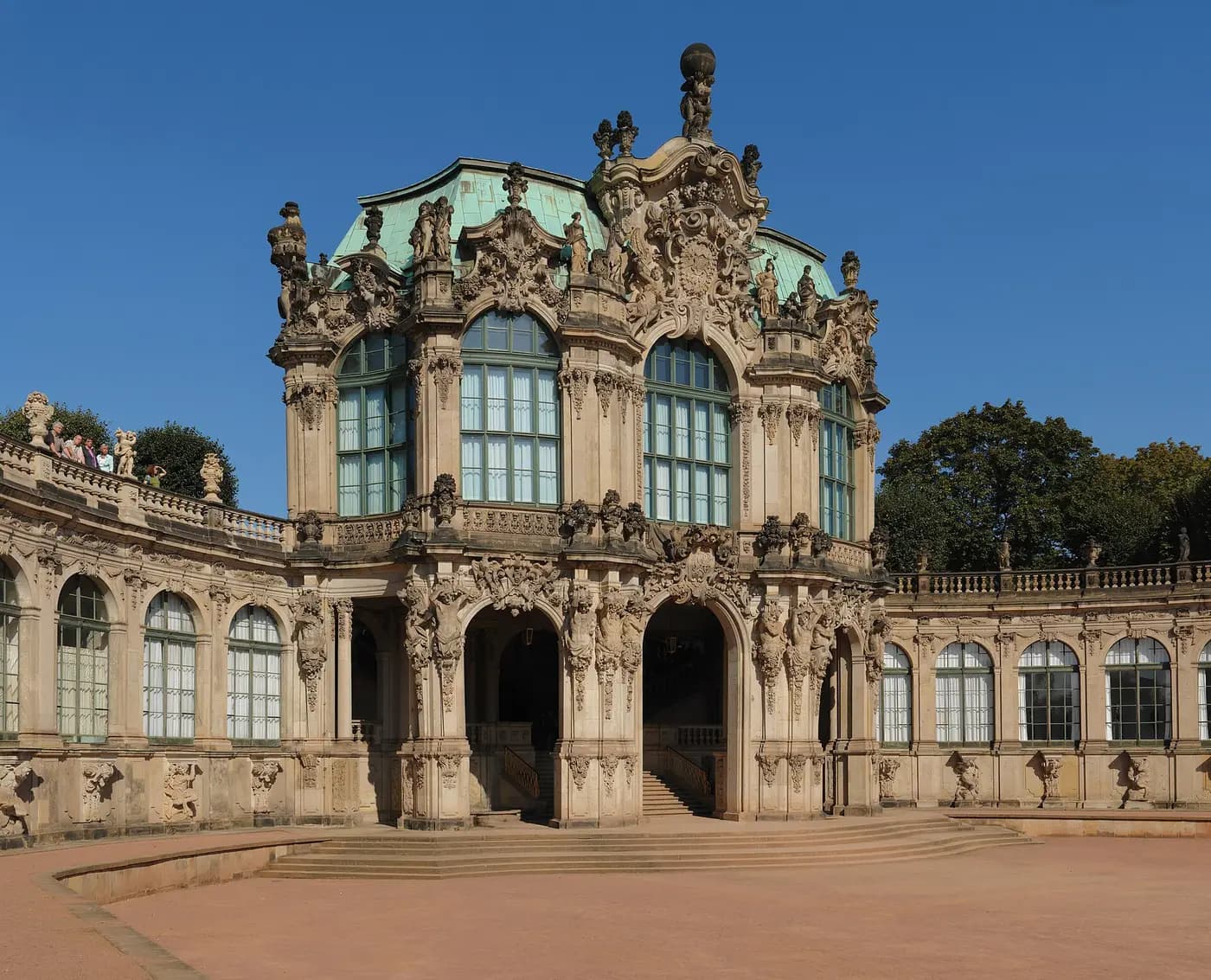 The ornate baroque Wall Pavilion of the Zwinger palace in Dresden under a blue sky