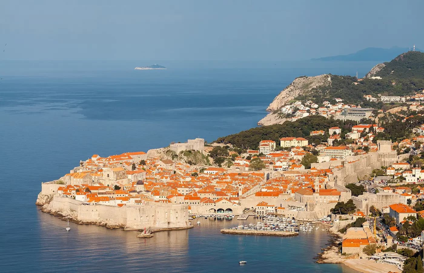 Dubrovnik's walled Old Town and terracotta roofs on a headland above the Adriatic, seen from above