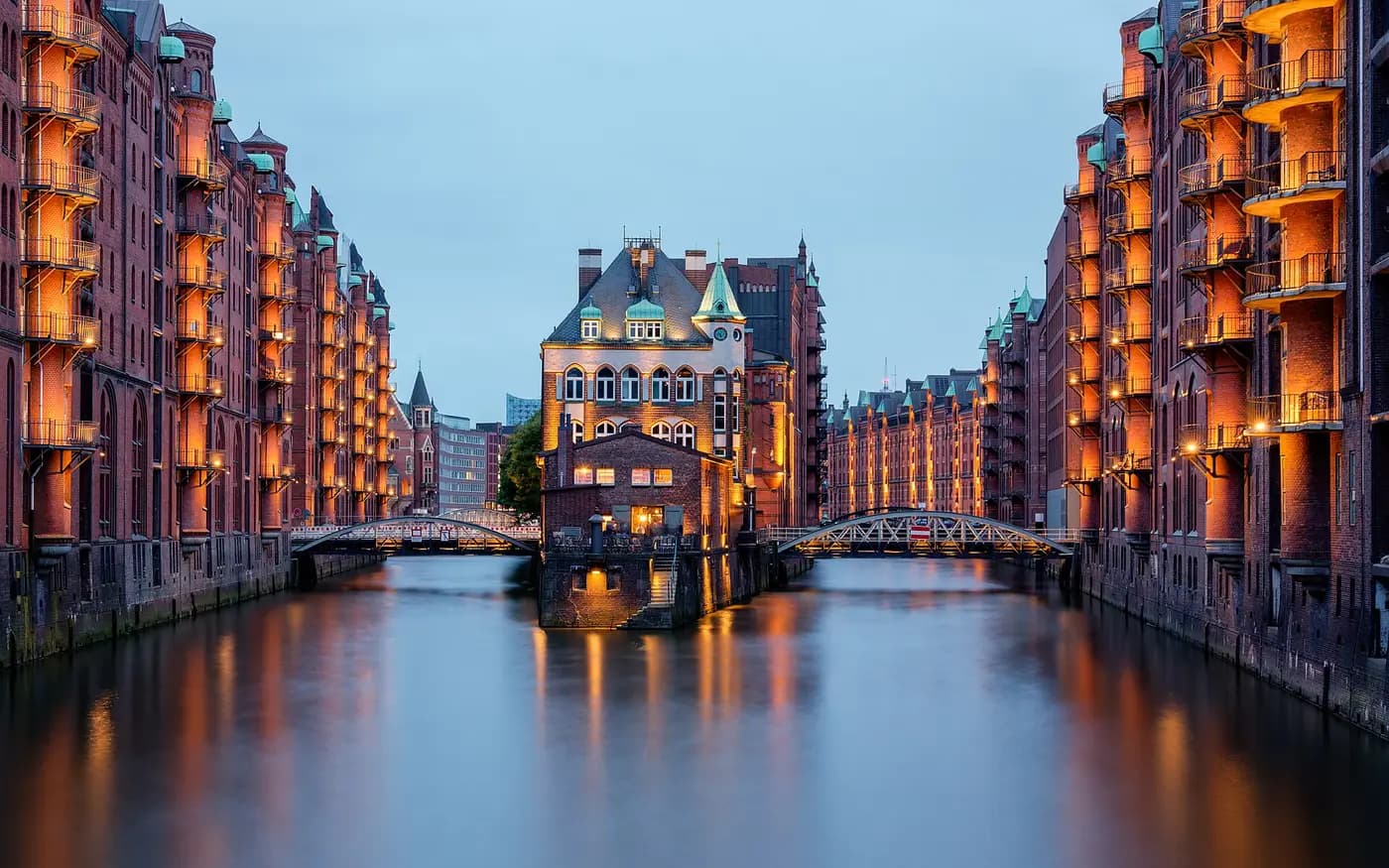 Red-brick warehouses of Hamburg's Speicherstadt lining two canals around the turreted Wasserschloss