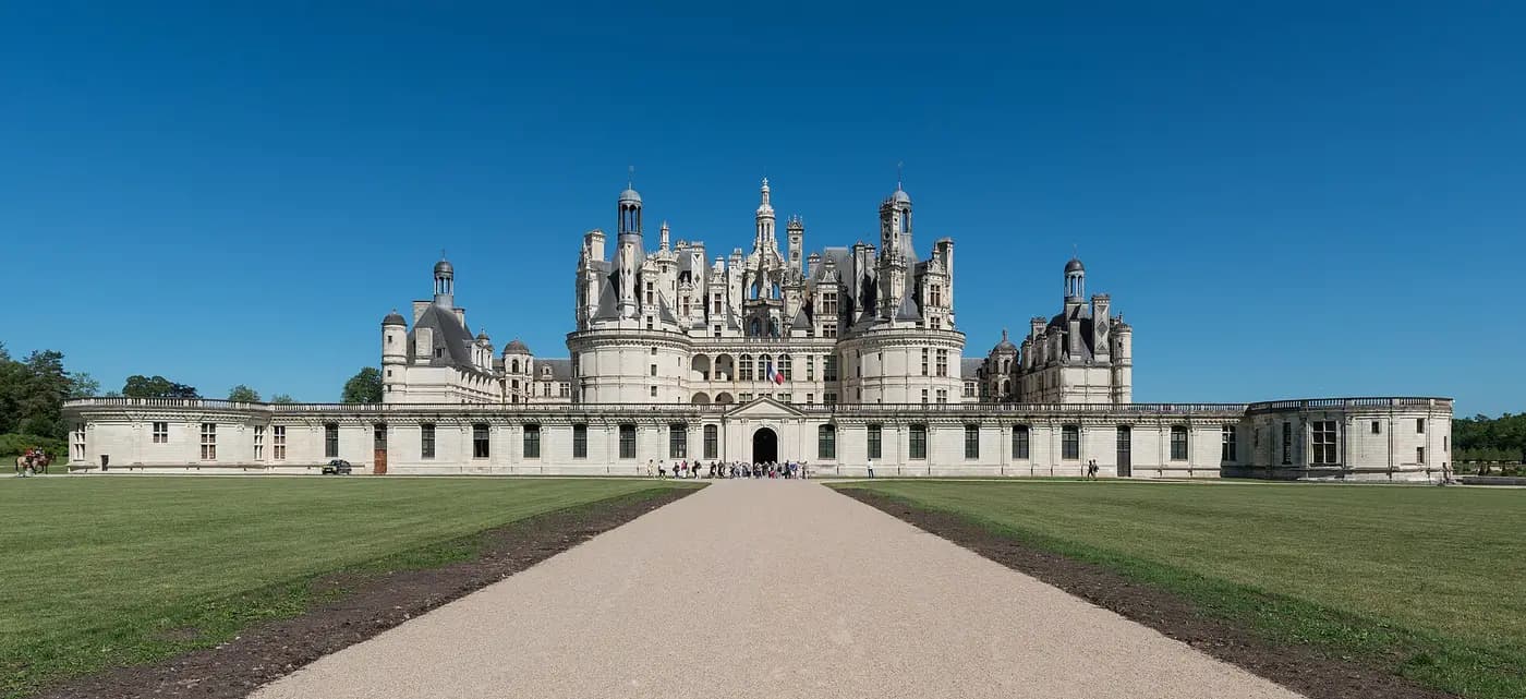 The Renaissance Château de Chambord with its forest of towers and chimneys, seen down a long avenue
