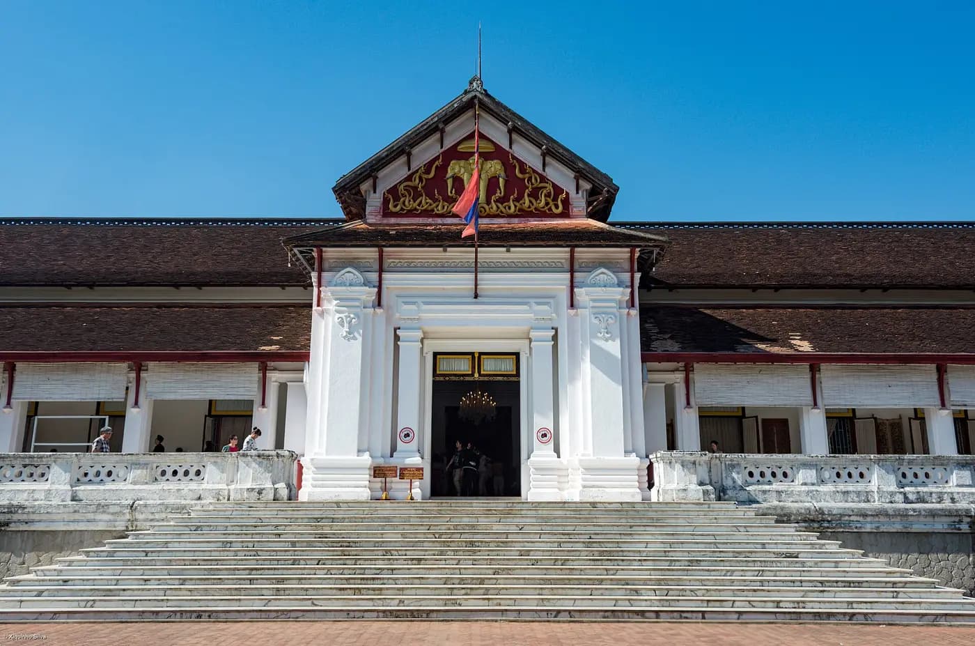 The white former Royal Palace of Luang Prabang, now the National Museum, at the top of its steps