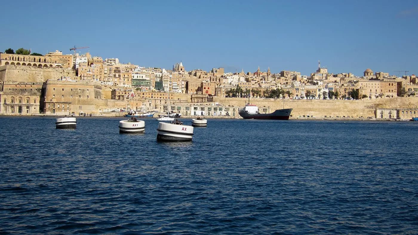 The bastions and honey-coloured buildings of Valletta seen across the water of the Grand Harbour