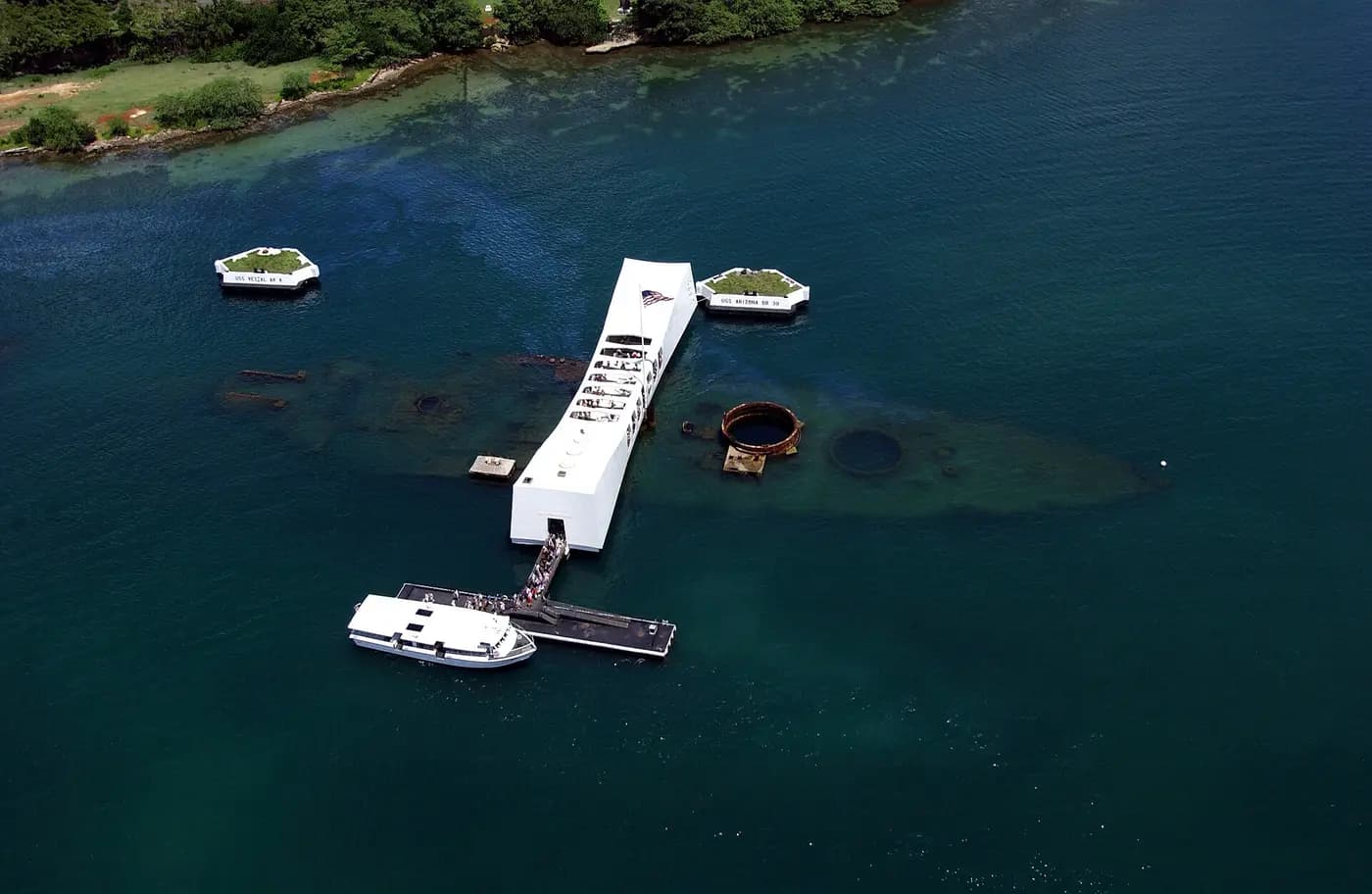 Aerial view of the USS Arizona Memorial over the sunken battleship at Pearl Harbor