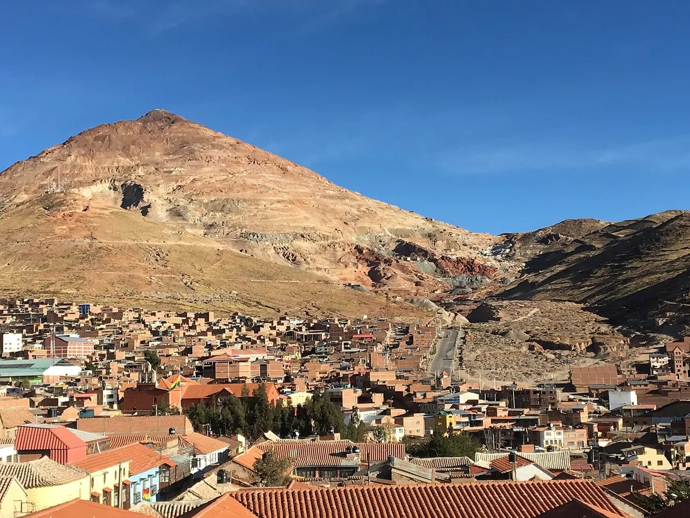 The bare red cone of Cerro Rico, the silver mountain, rising above the rooftops of Potosí