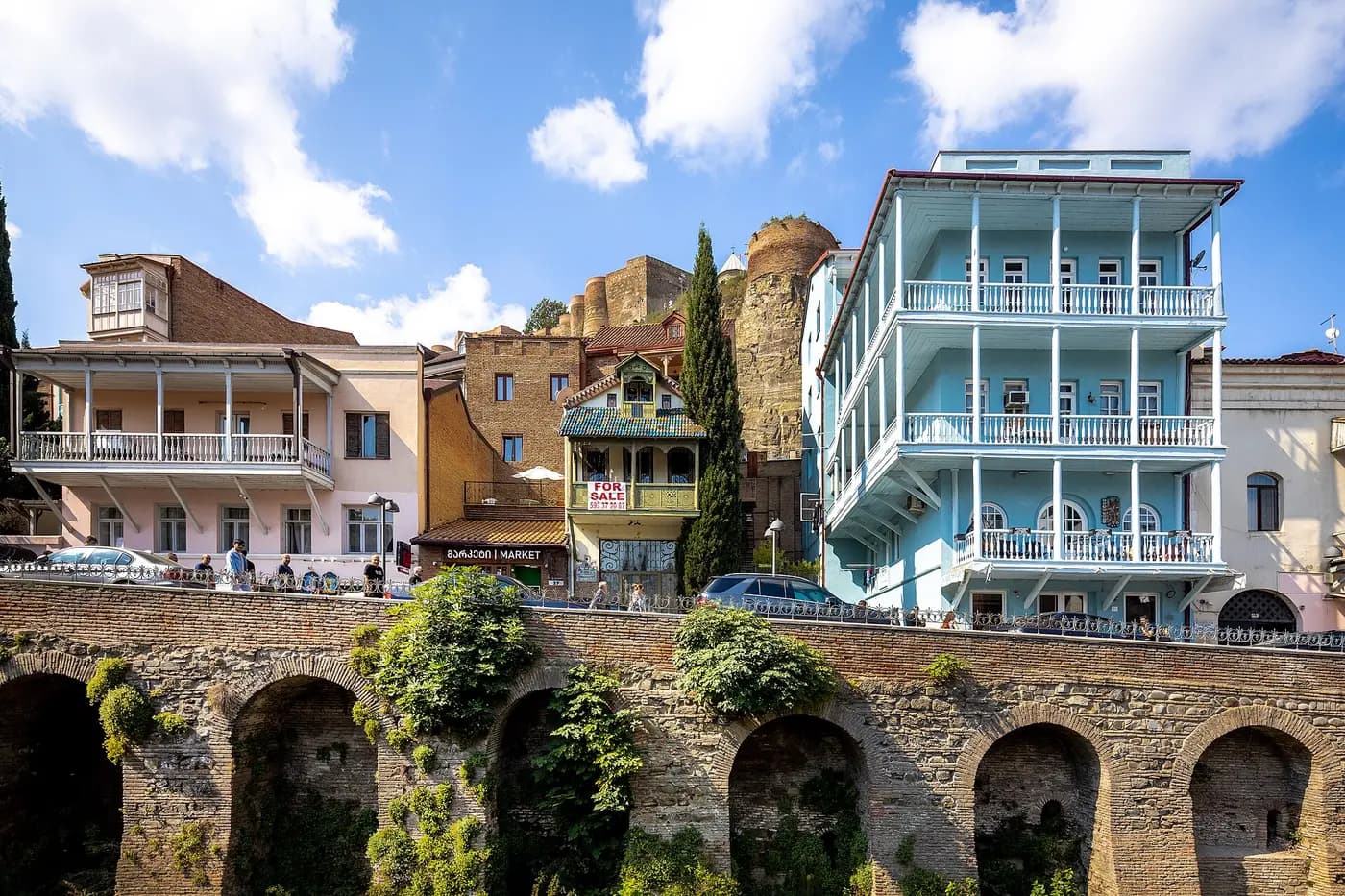 Old houses with carved wooden balconies above the arched walls of Abanotubani, Tbilisi's bath district