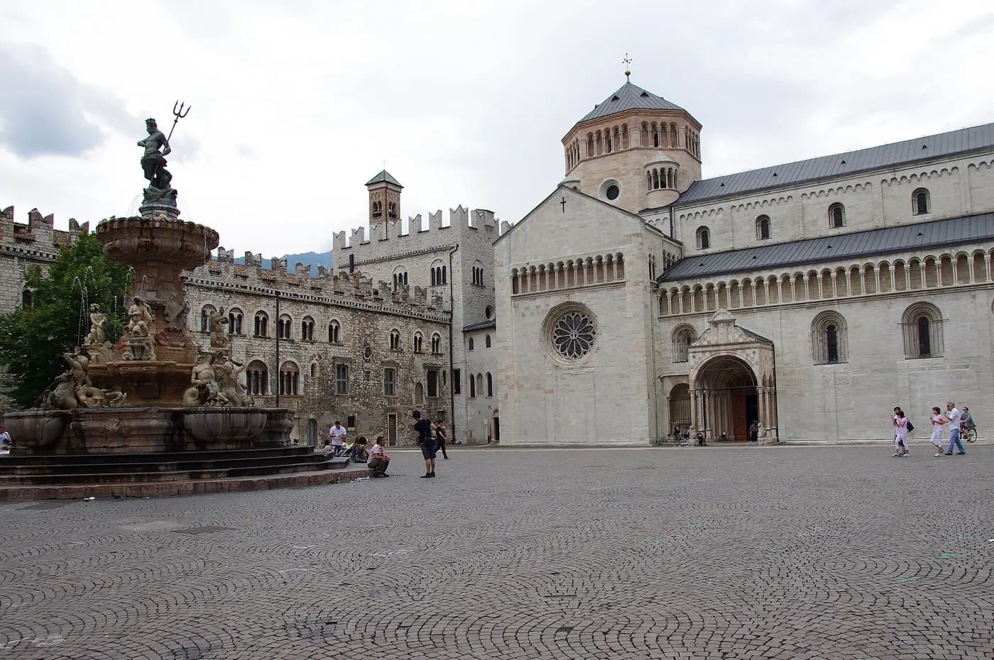 Trento Cathedral and the Neptune Fountain on Piazza del Duomo, with medieval crenellated palaces alongside