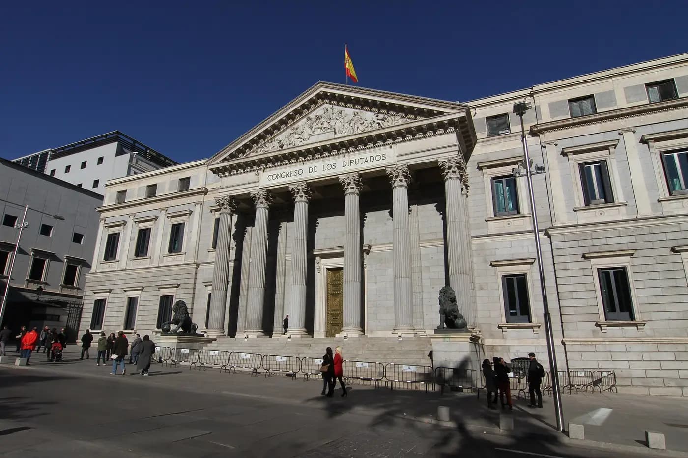 The columned facade of Spain's Congress of Deputies in Madrid, flanked by bronze lions