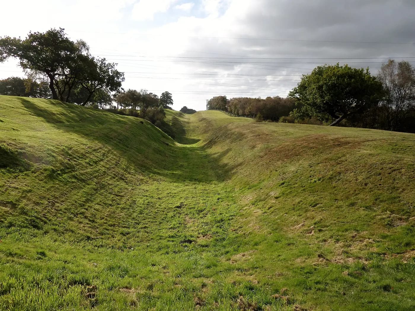 The deep grassy ditch in front of the Antonine Wall at Rough Castle, near Falkirk