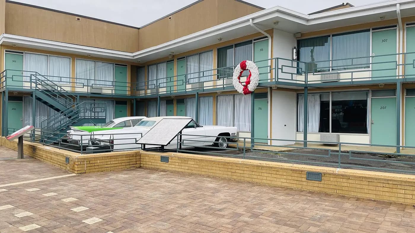 The Lorraine Motel in Memphis, with a wreath on the balcony outside Room 306 and two 1960s cars below