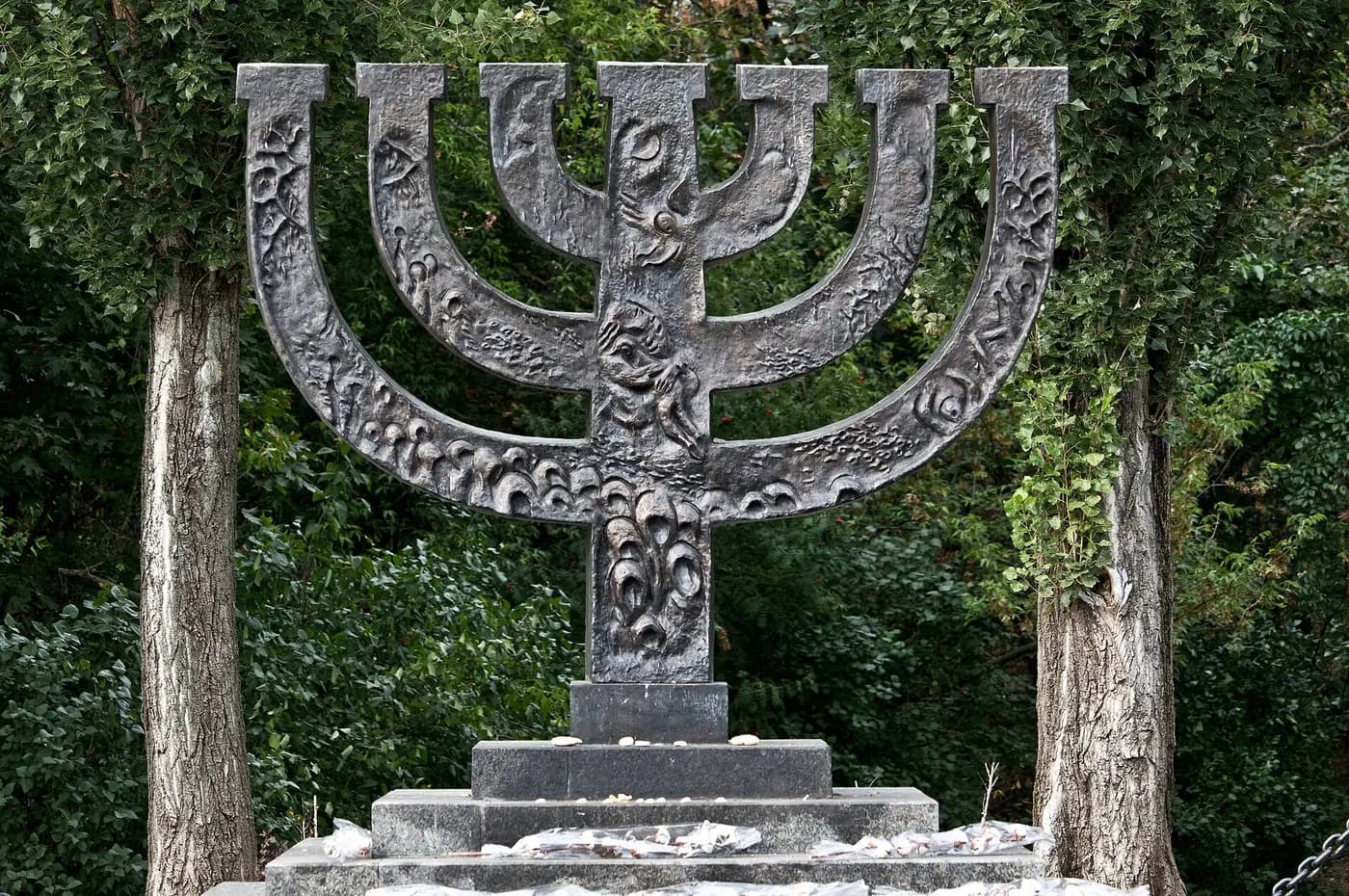 The Menorah memorial at Babyn Yar in Kyiv, standing among trees