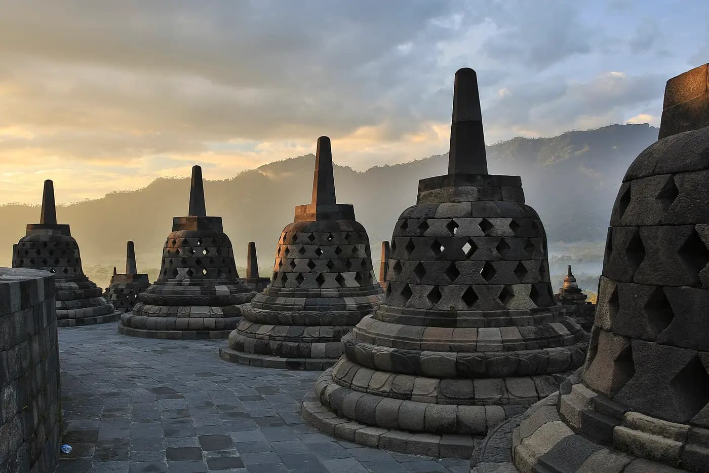 Bell-shaped perforated stone stupas on the upper terraces of Borobudur