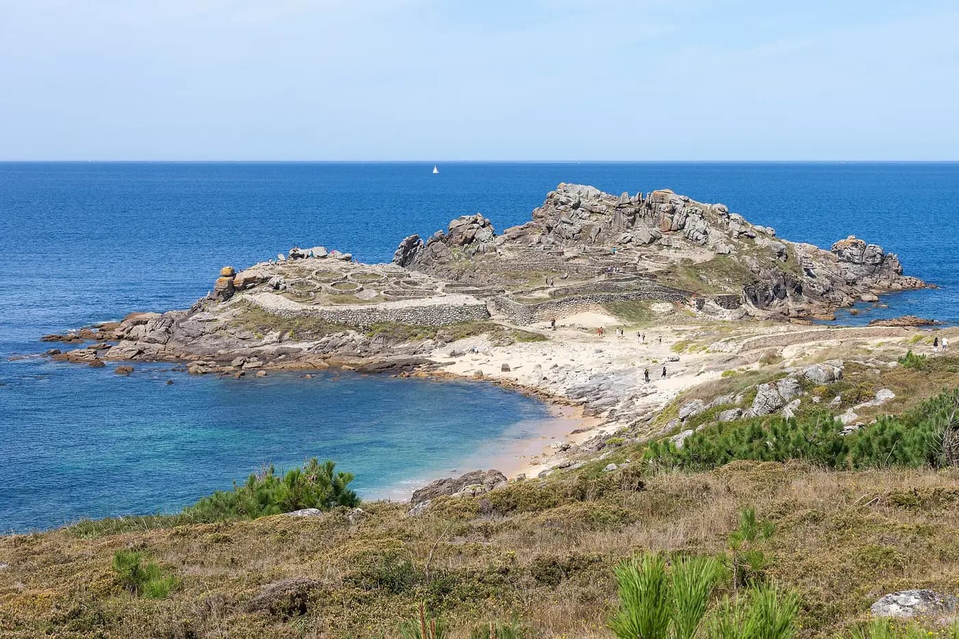 The Iron Age hillfort of Baroña on a rocky headland above an Atlantic beach