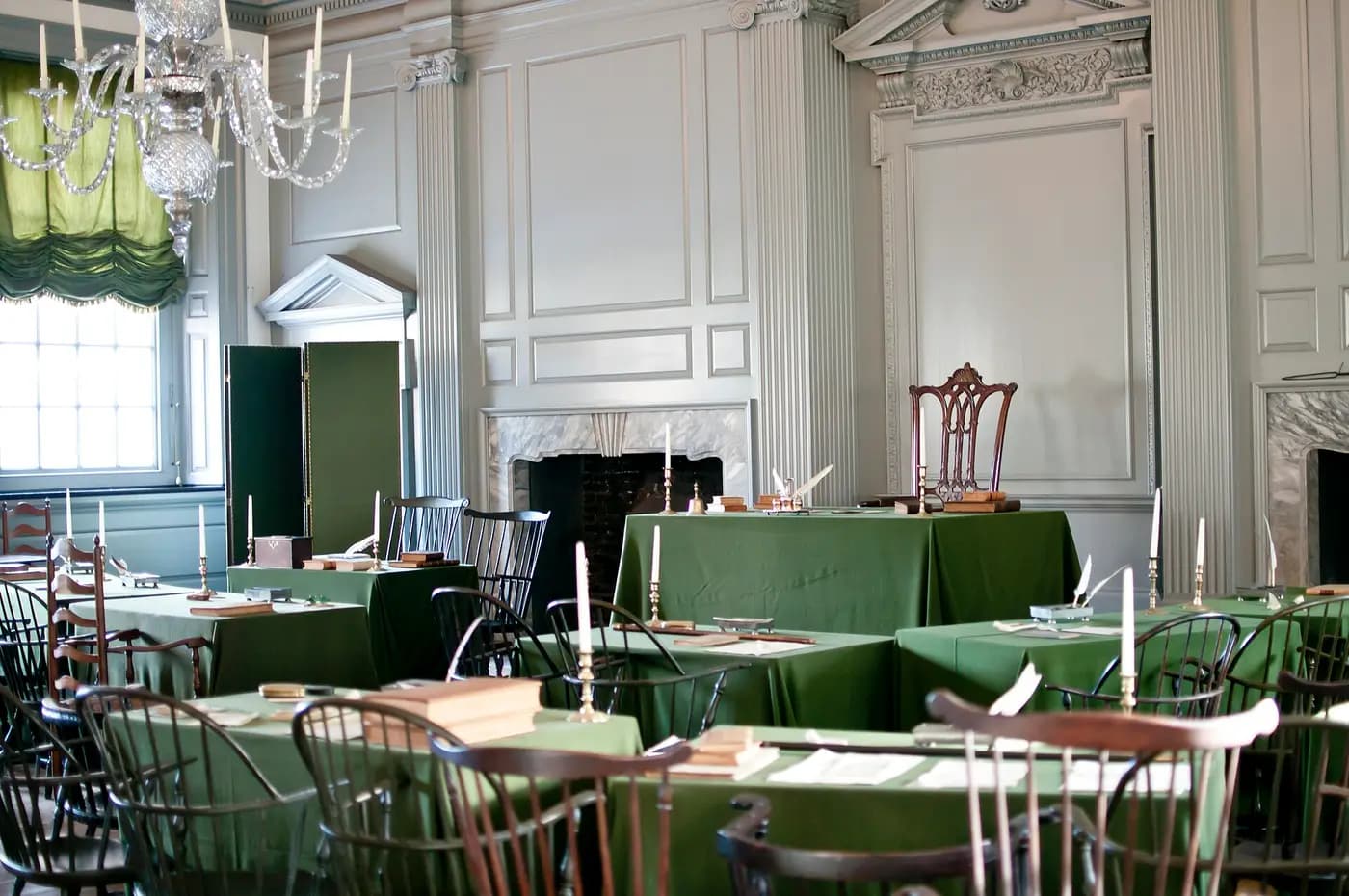 The Assembly Room of Independence Hall, with wooden chairs and green baize-covered tables