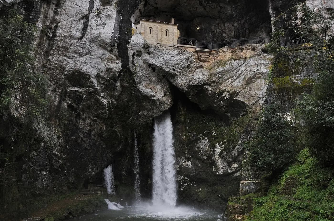 The chapel in the Holy Cave of Covadonga, set in a cliff above a waterfall