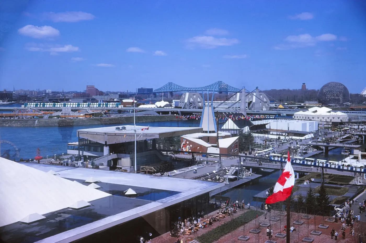 Expo 67 pavilions on the islands in 1967, with the Jacques Cartier Bridge and the US geodesic dome beyond