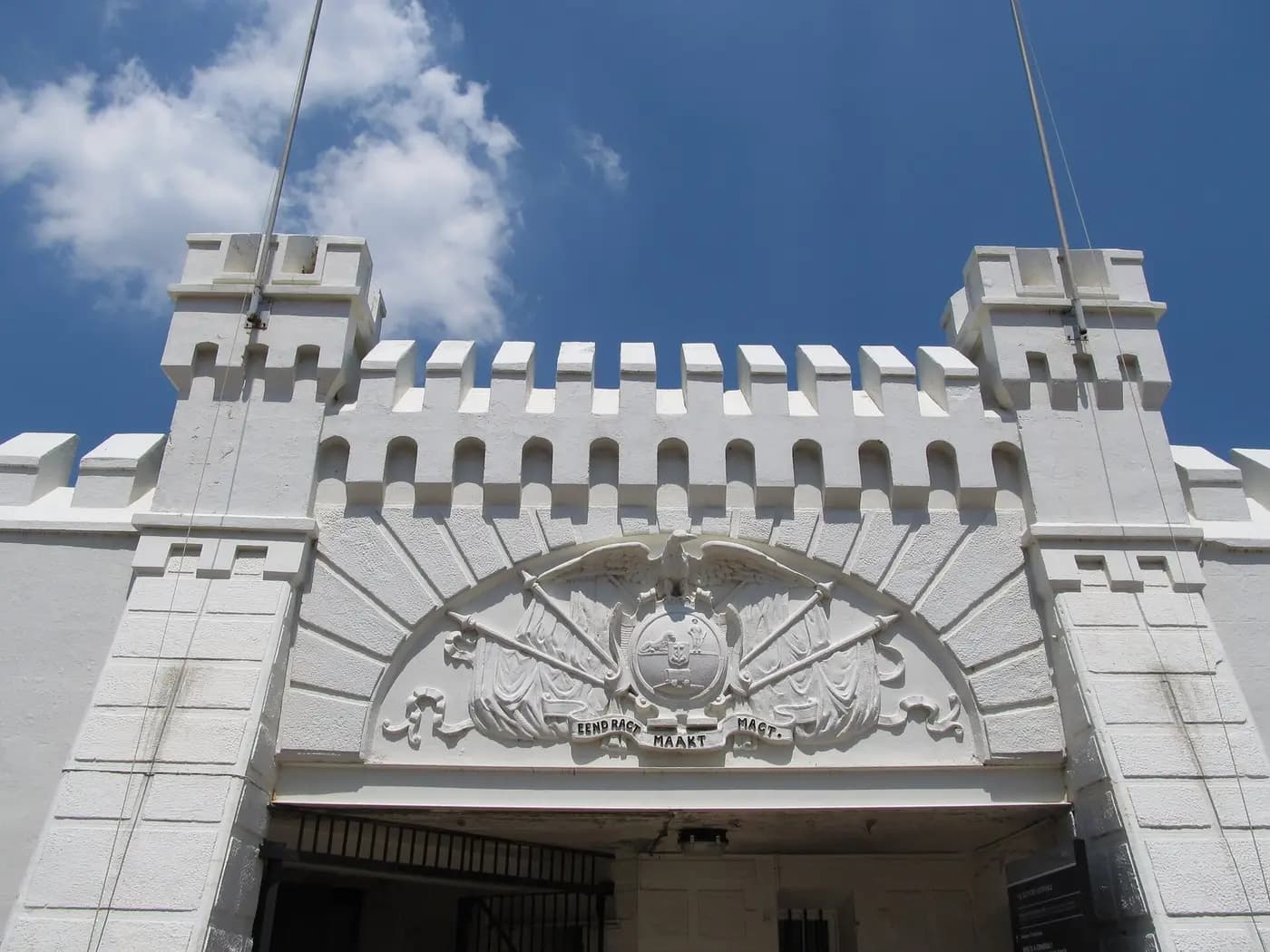 Whitewashed gateway of Johannesburg's Old Fort prison, topped by the old republic's coat of arms