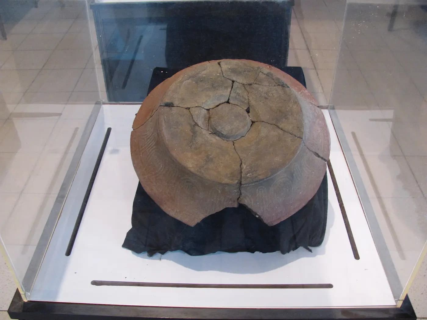 A large Lapita pottery dish with stamped decoration in a display case at the Vanuatu Cultural Centre