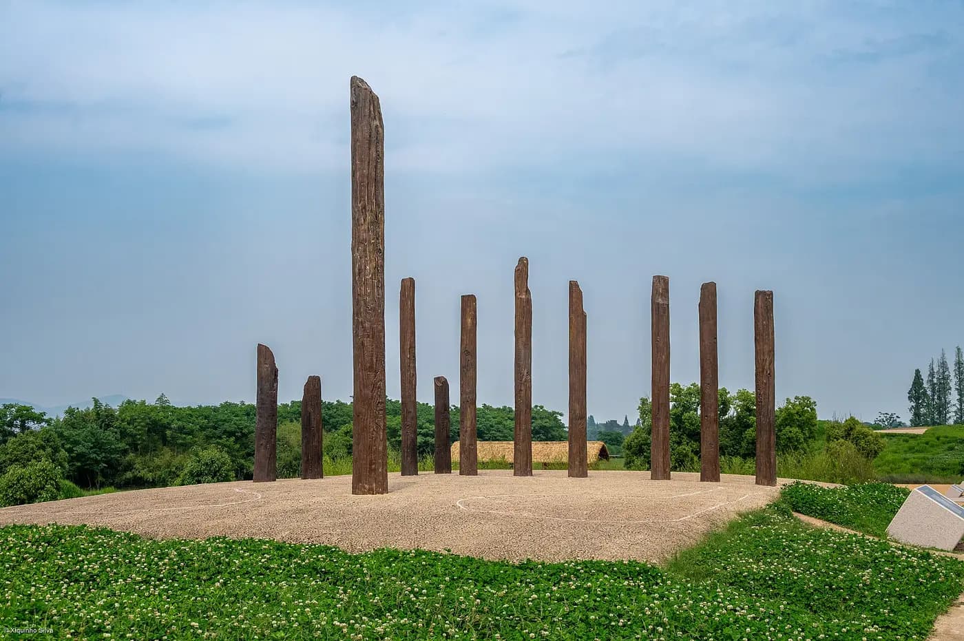 Timber posts marking an excavated building on a platform in the Liangzhu archaeological park
