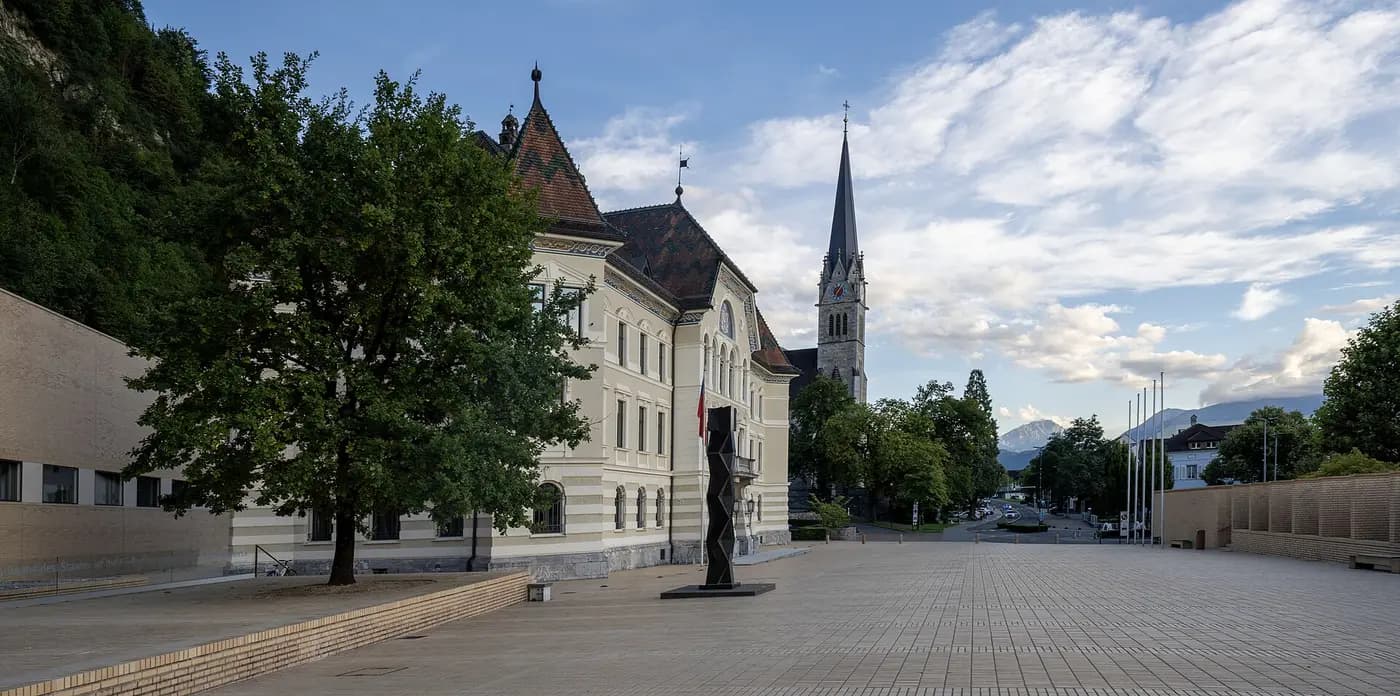 Liechtenstein's Government House on Peter-Kaiser-Platz in Vaduz, with the cathedral spire beyond