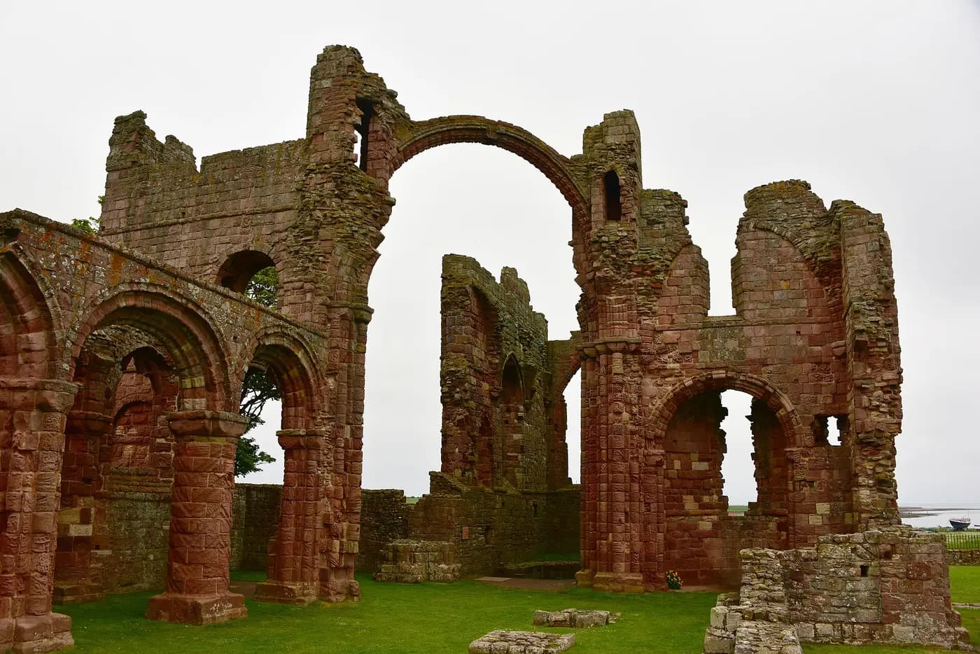 The ruined red sandstone arches of Lindisfarne Priory on Holy Island