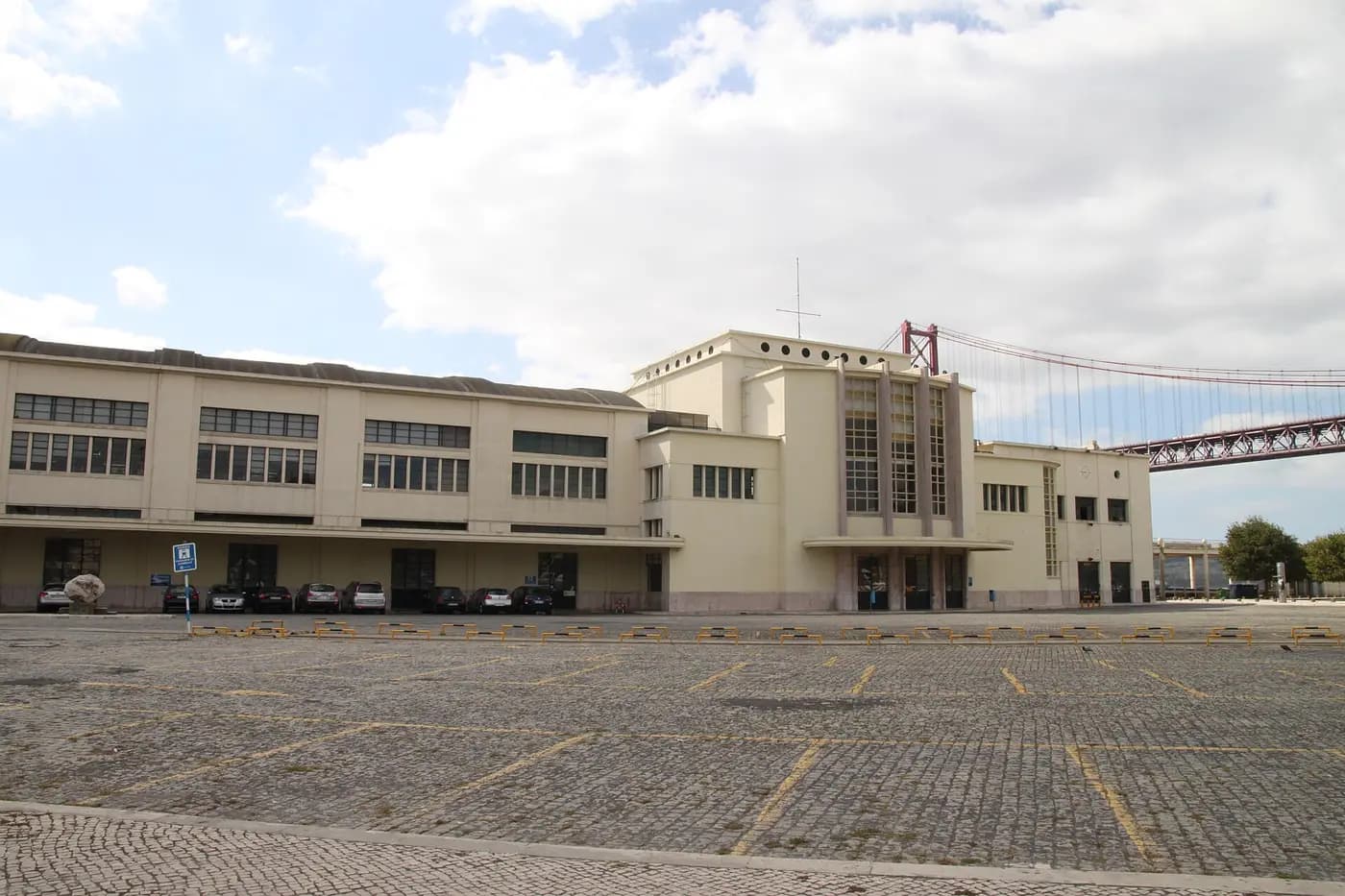 The 1940s Alcântara maritime terminal on Lisbon's waterfront, with the 25 de Abril Bridge behind