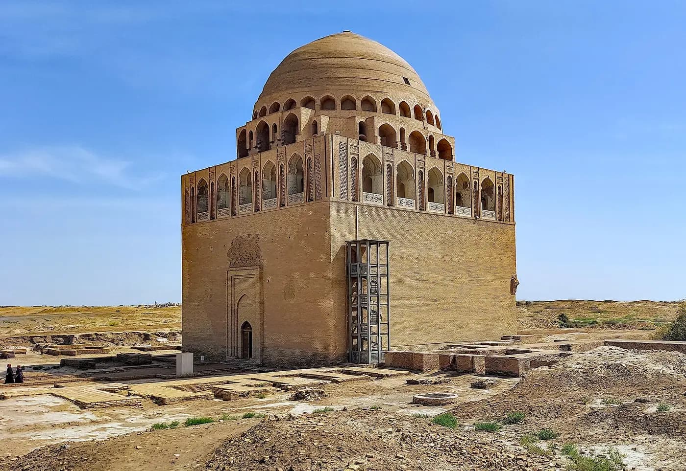 The domed brick mausoleum of Sultan Sanjar standing among excavated ruins at Merv