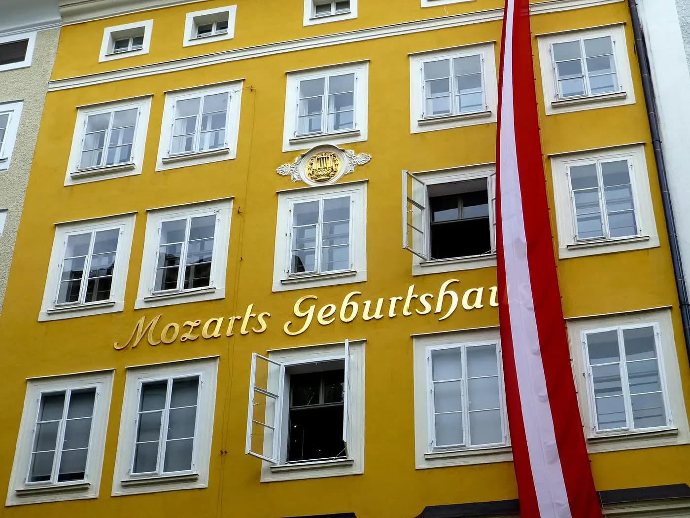 The yellow facade of Mozart's birthplace in Salzburg, lettered with its name