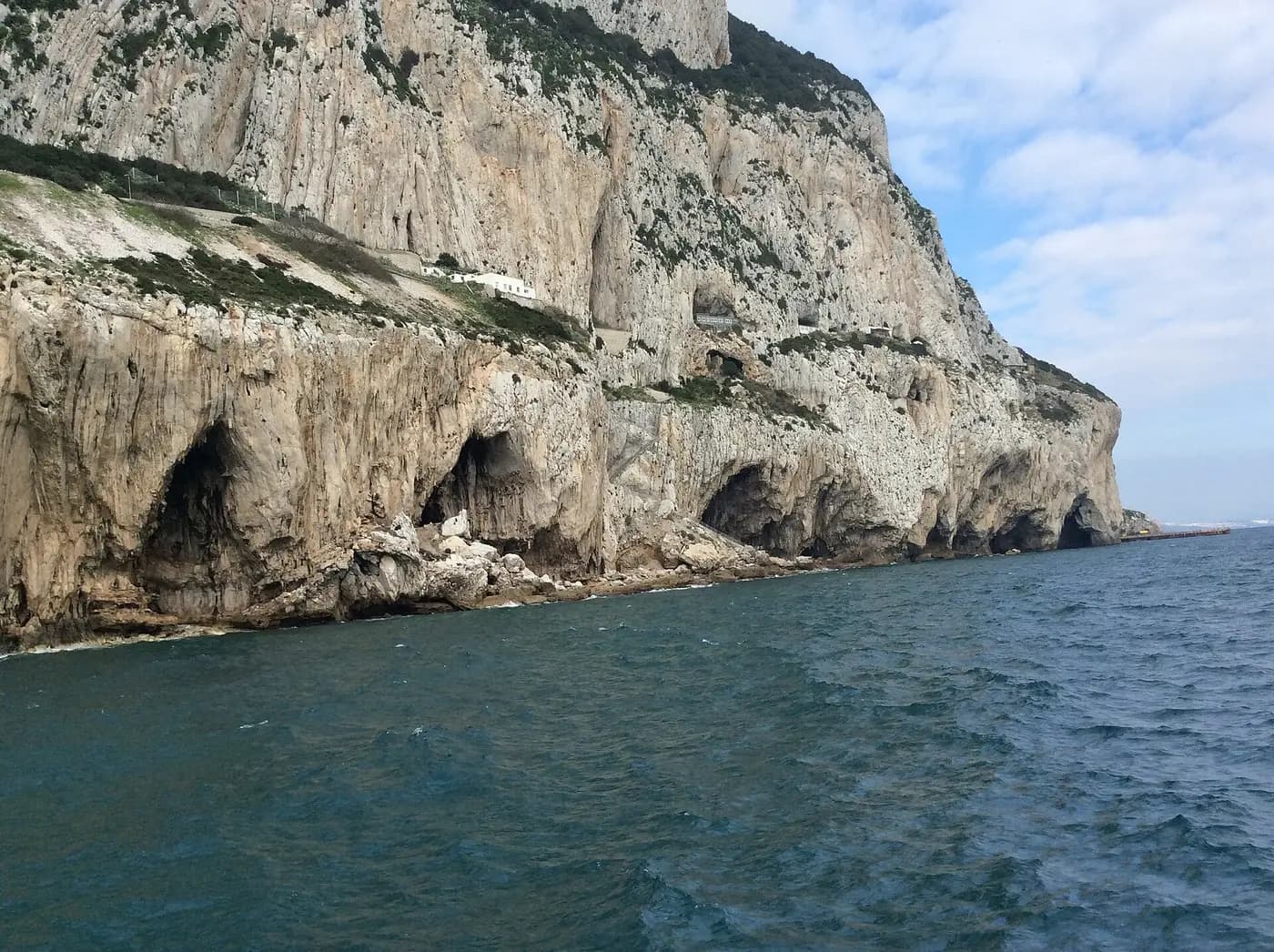 Sea caves at the foot of the Rock of Gibraltar's eastern cliffs, seen from the water
