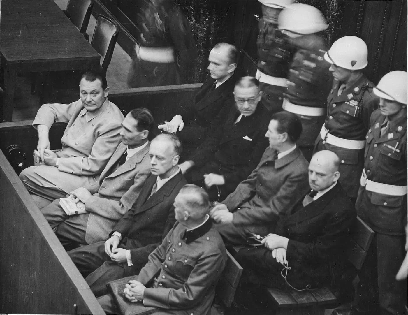 The defendants seated in the dock at the Nuremberg trials, guarded by military police