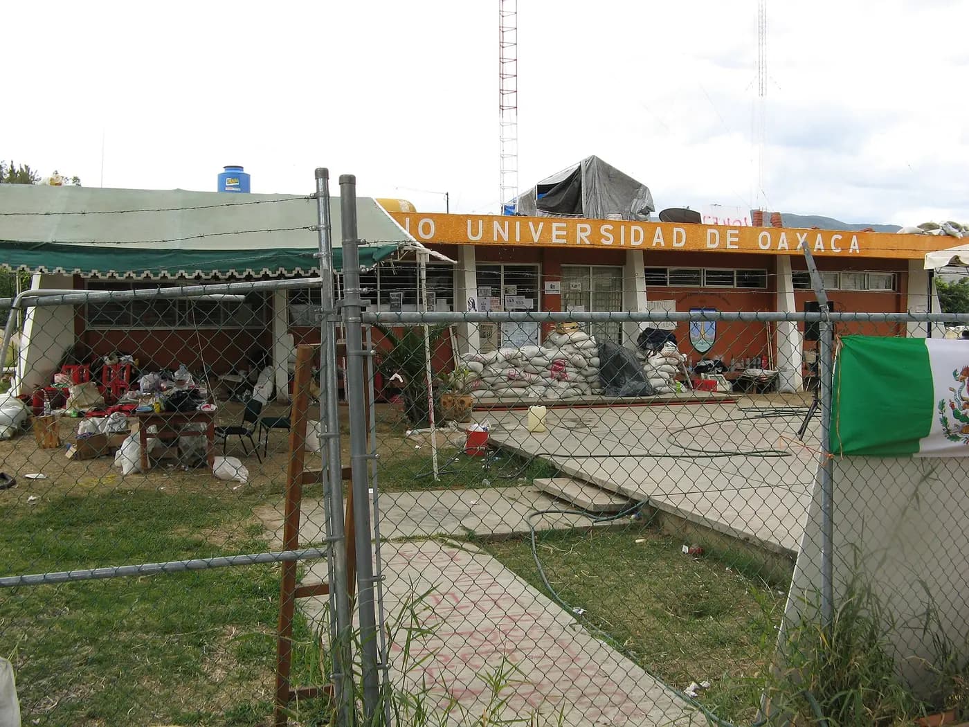 Sandbags, tarpaulin shelters and a Mexican flag outside the Radio Universidad studios in Oaxaca in November 2006
