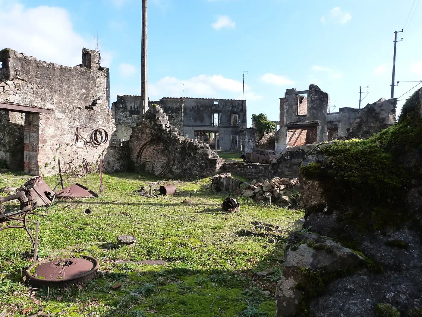 Burnt-out ruined houses lining the street of the preserved martyr village of Oradour-sur-Glane