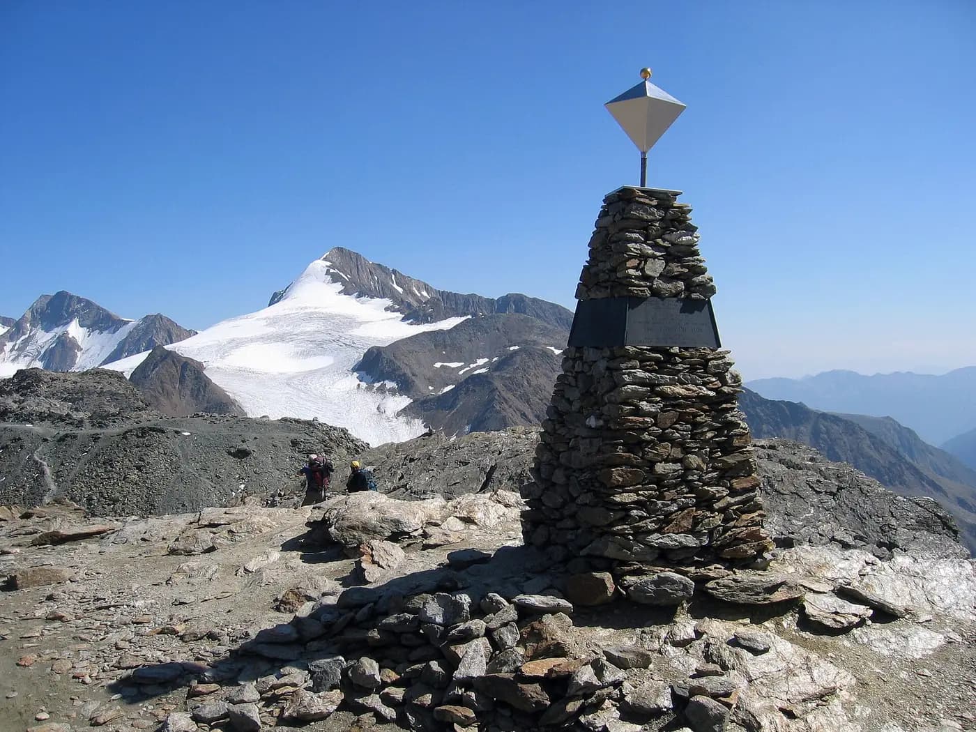 A stone obelisk near the Iceman find site on the Tisenjoch, with the snowy Similaun behind
