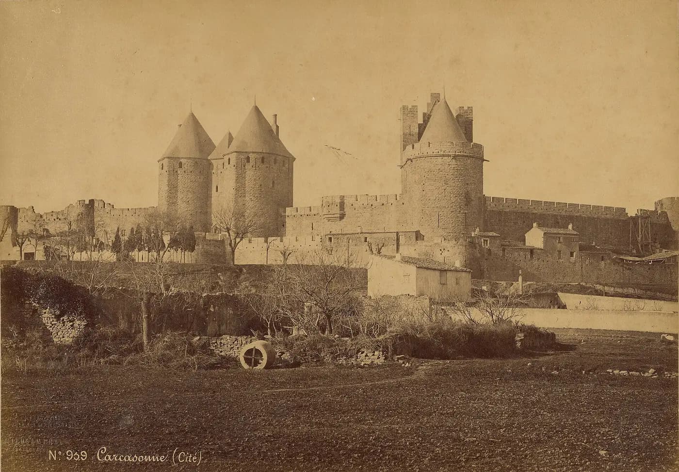 Nineteenth-century photograph of Carcassonne's walls and towers wearing the pointed roofs of the restoration