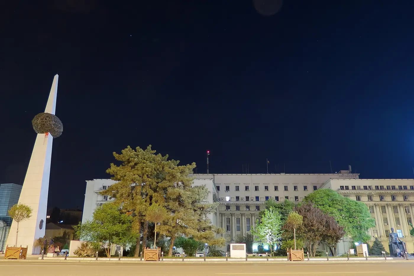 Bucharest's Revolution Square at night, with the Memorial of Rebirth and the former Central Committee building