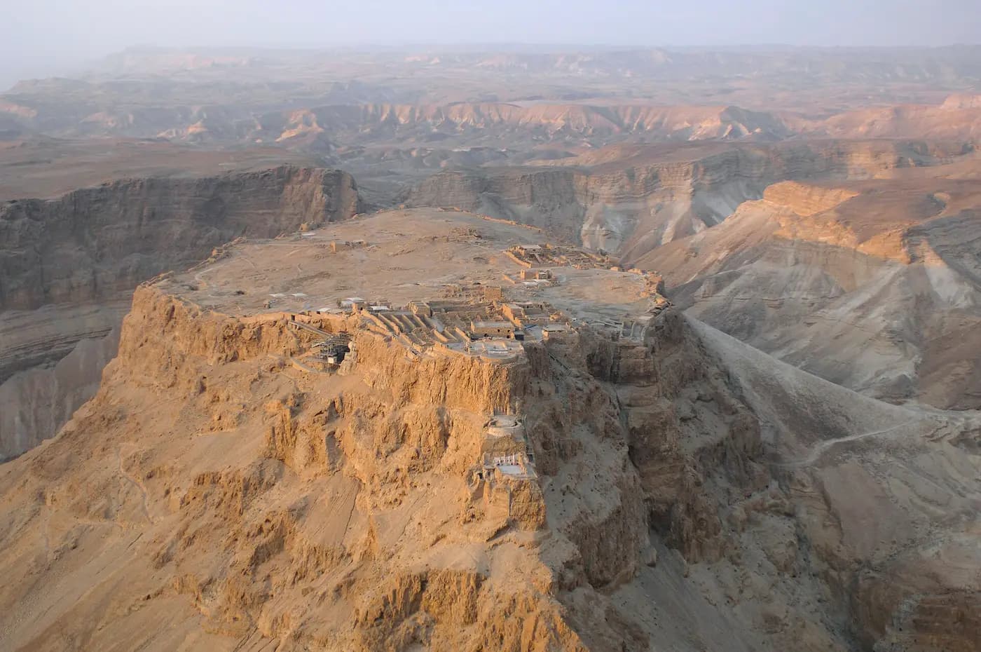 Aerial view of the flat-topped desert mesa of Masada above the Dead Sea basin
