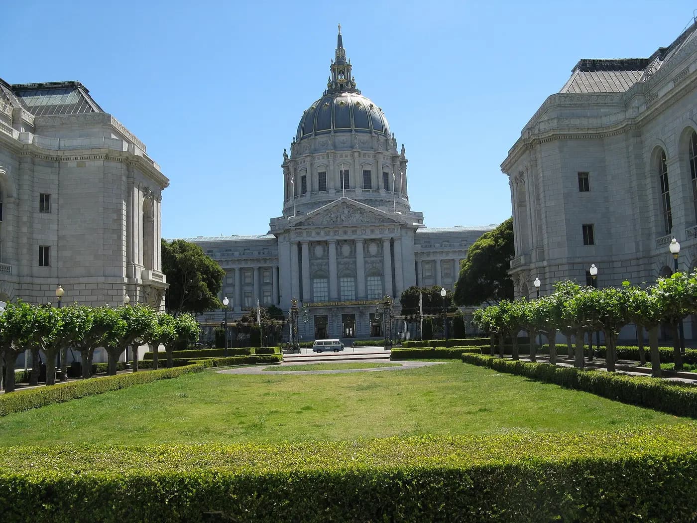 San Francisco City Hall's dome between the War Memorial Opera House and Veterans Building, across a lawn