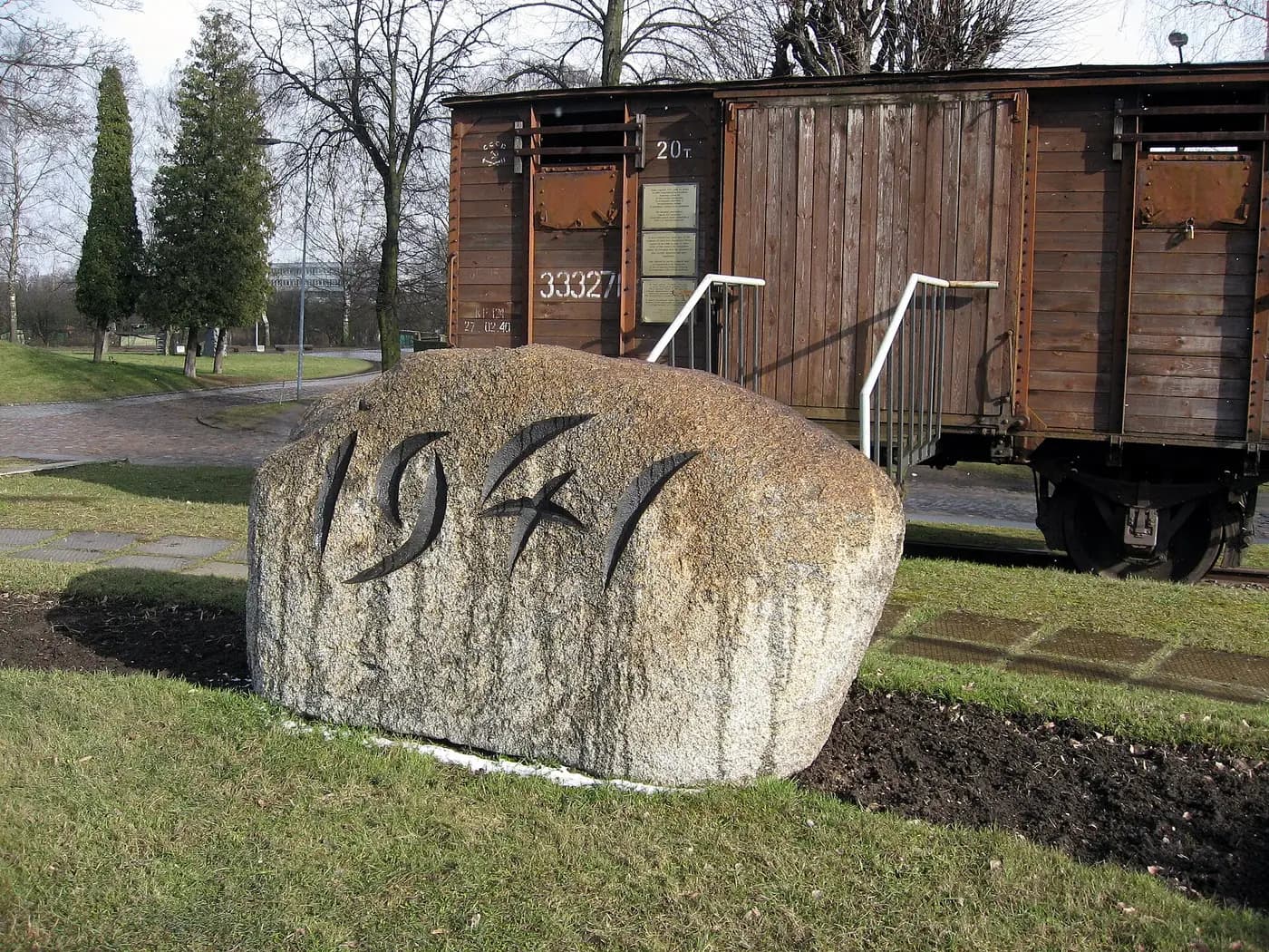 A wooden cattle wagon and a boulder carved with 1941 at the Torņakalns deportation memorial in Riga