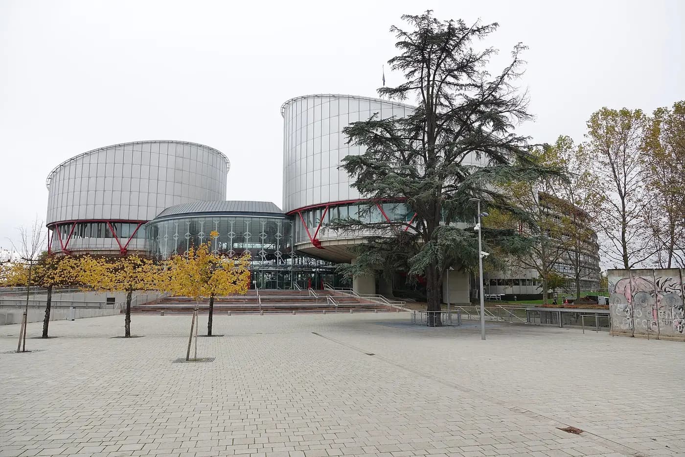 The twin drum-shaped towers of the European Court of Human Rights in Strasbourg, behind a paved forecourt