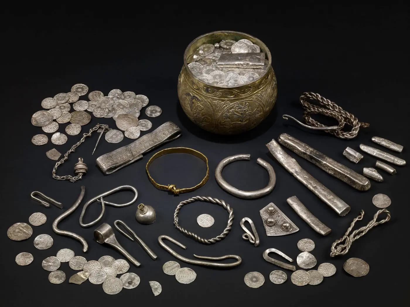 Silver coins, ingots and arm-rings of the Viking-age Vale of York Hoard around a gilt cup