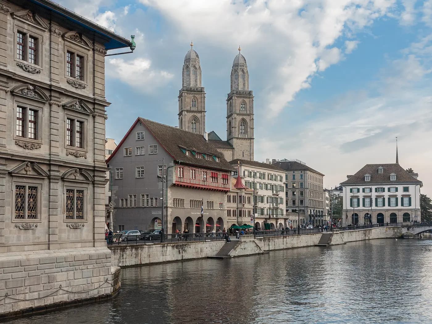 The twin towers of the Grossmünster rising above the Limmatquai and the river in Zurich