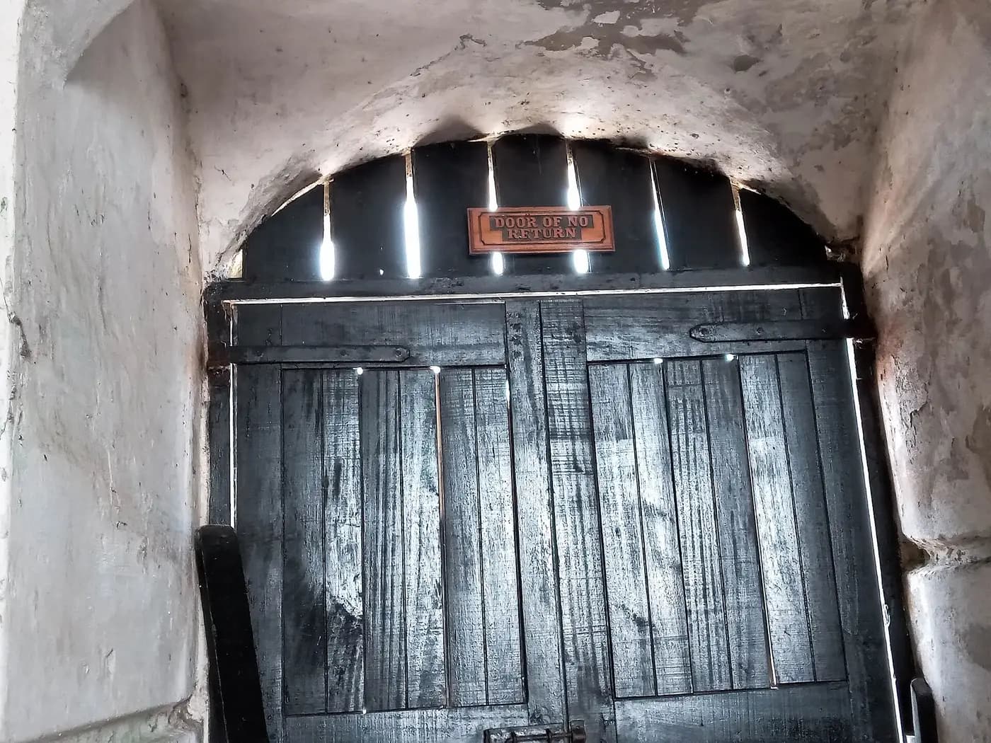 The heavy wooden Door of No Return inside Cape Coast Castle, Ghana, where captives were led to the ships