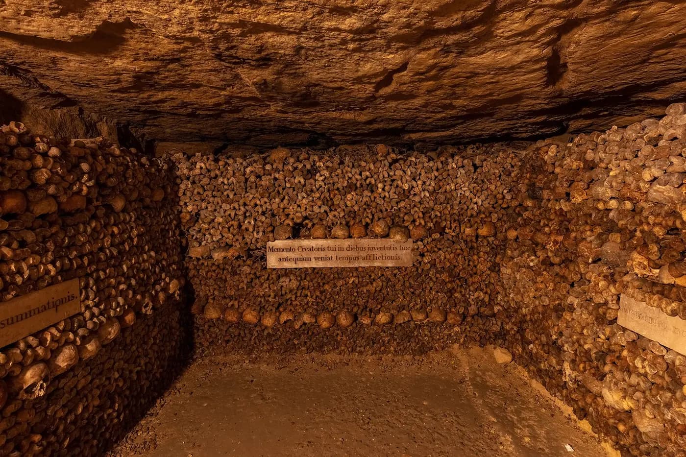 Bones stacked along a passage in the Paris catacombs