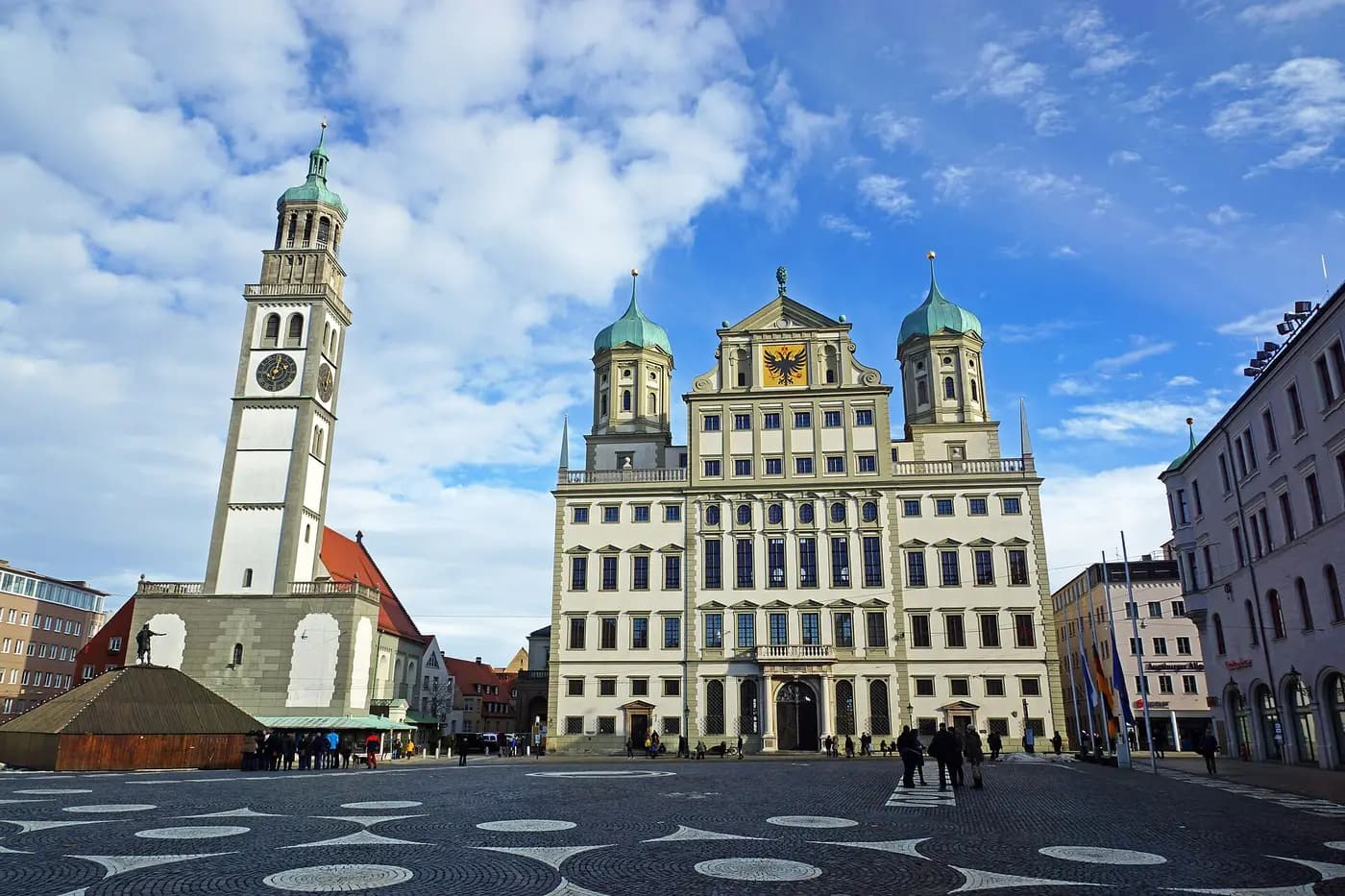 Augsburg's Renaissance town hall with its twin onion domes beside the slender Perlach Tower on Rathausplatz