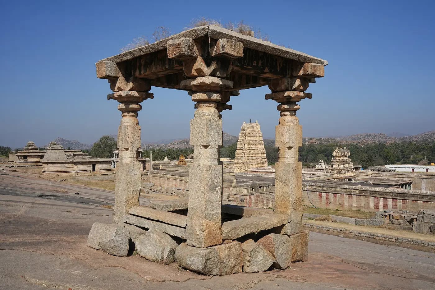 The tall gateway tower of the Virupaksha Temple among the ruins of Hampi, seen from Hemakuta Hill