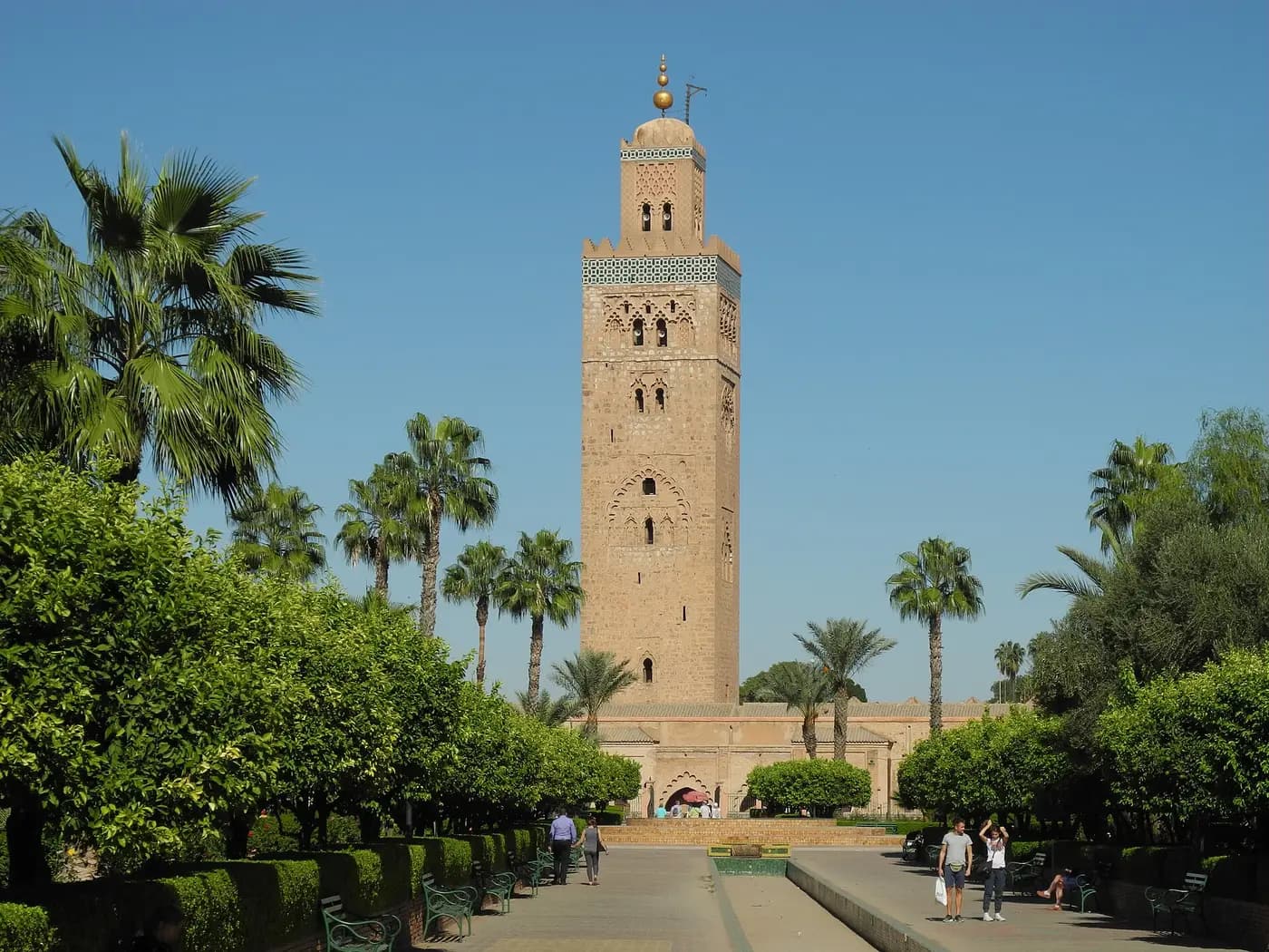 The Almohad minaret of the Koutoubia Mosque rising above palms in Marrakesh