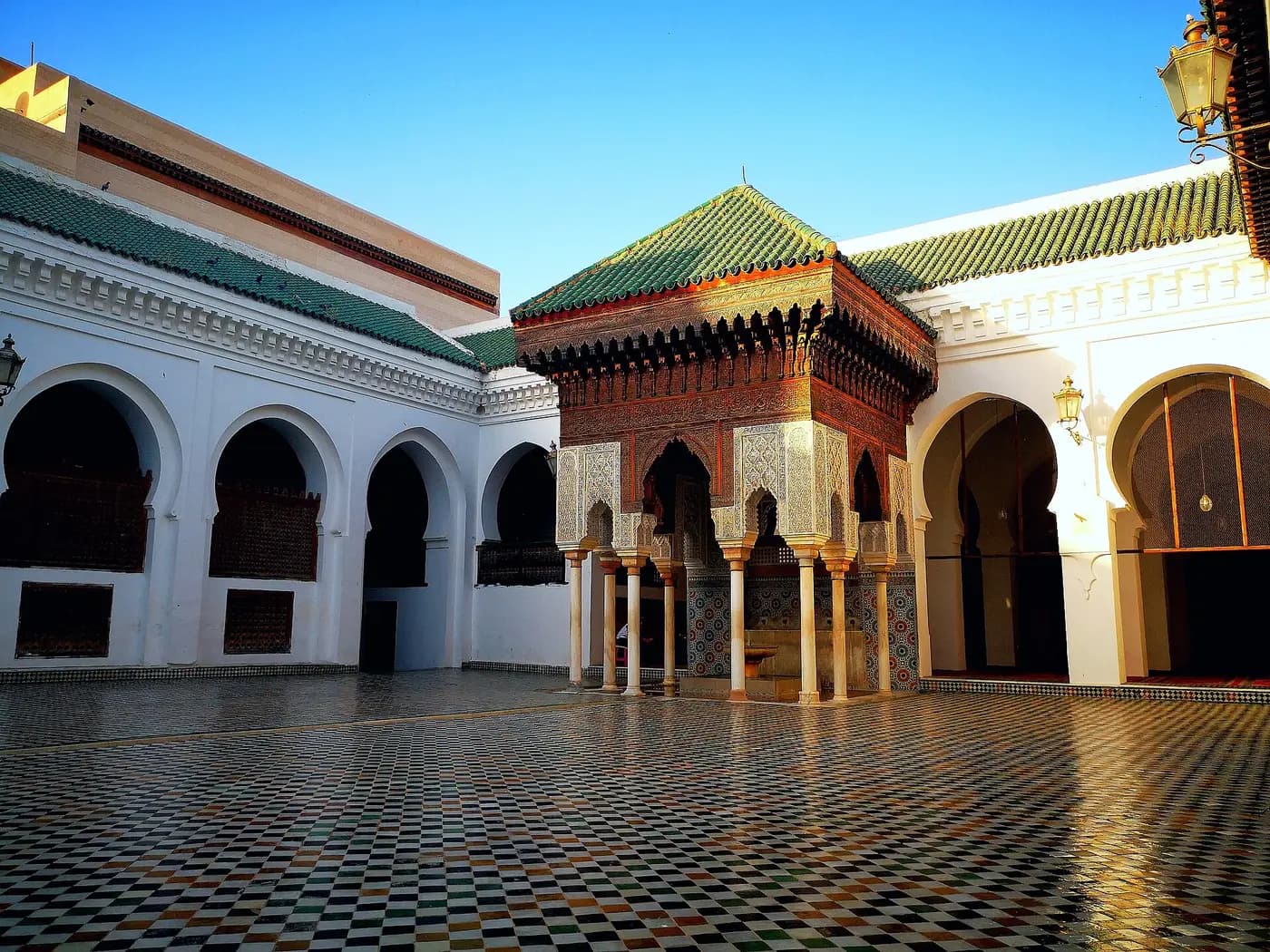 The tiled courtyard of al-Qarawiyyin in Fez, with a green-roofed pavilion and white arcades