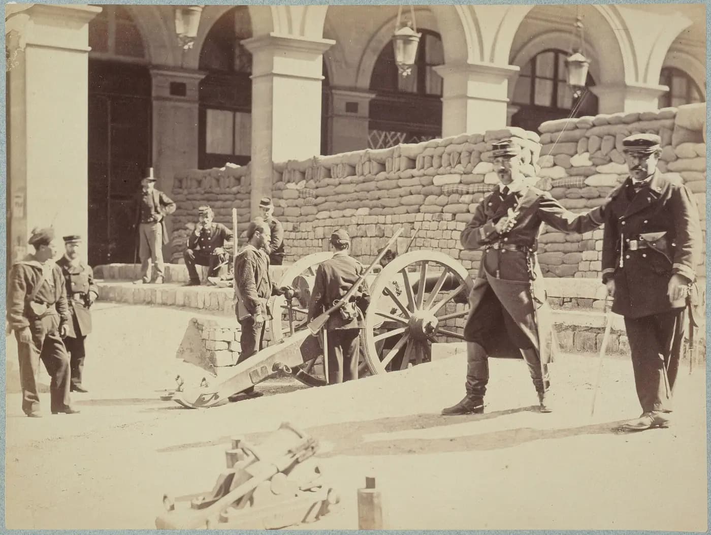 National Guards pose with a cannon behind a sandbag barricade in rue de Castiglione, Paris, 1871
